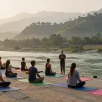 Yoga teacher training in Rishikesh, students practicing yoga with scenic Himalayas.